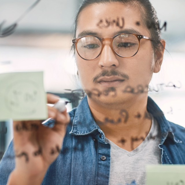 man writing on whiteboard
